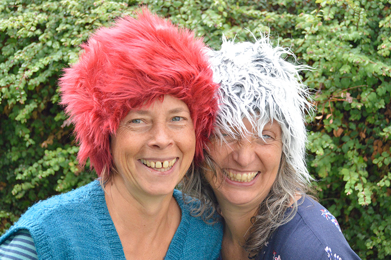 women-laughing-wearing-furry-hats